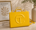 Telfar Shopping Bag in yellow vegan leather with embossed logo and detachable shoulder strap