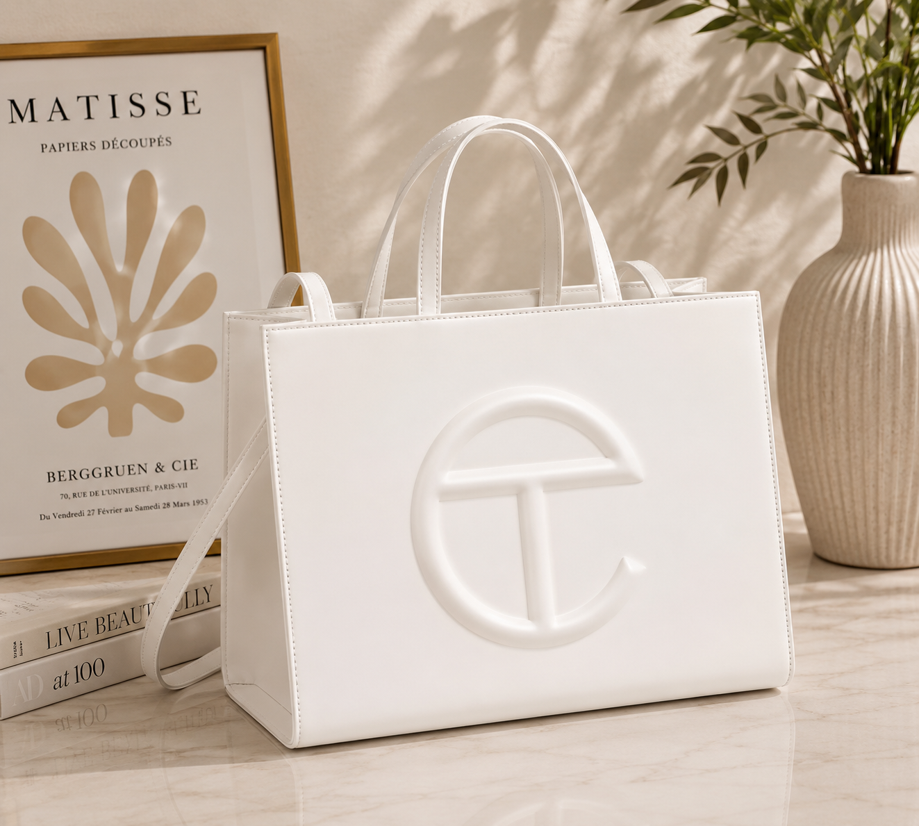 Telfar Shopping Bag in white vegan leather with tonal embossed logo and detachable shoulder strap