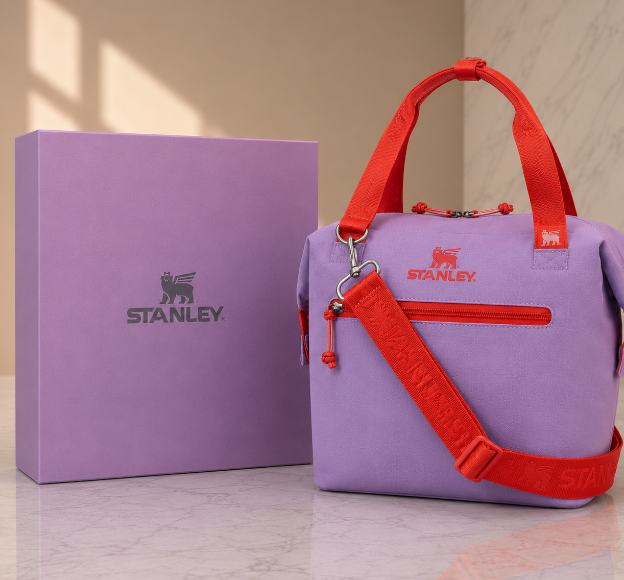 Stanley soft cooler lunch bag in lavender purple with red handles and crossbody strap, shown with gift box