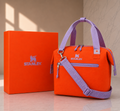 Stanley soft cooler lunch bag in orange with lavender handles and crossbody strap, shown with orange Stanley gift box