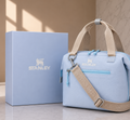 Stanley soft cooler lunch bag in baby blue with tan handles and crossbody strap, shown with light blue Stanley gift box