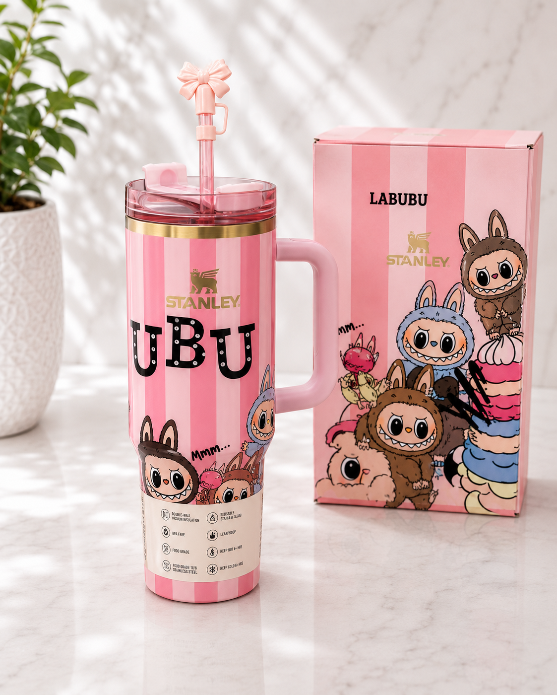 Stanley x Labubu 40oz Quencher tumbler in pink and white stripe with Labubu character print, pink bow straw topper and handle, shown with matching Labubu x Stanley gift box