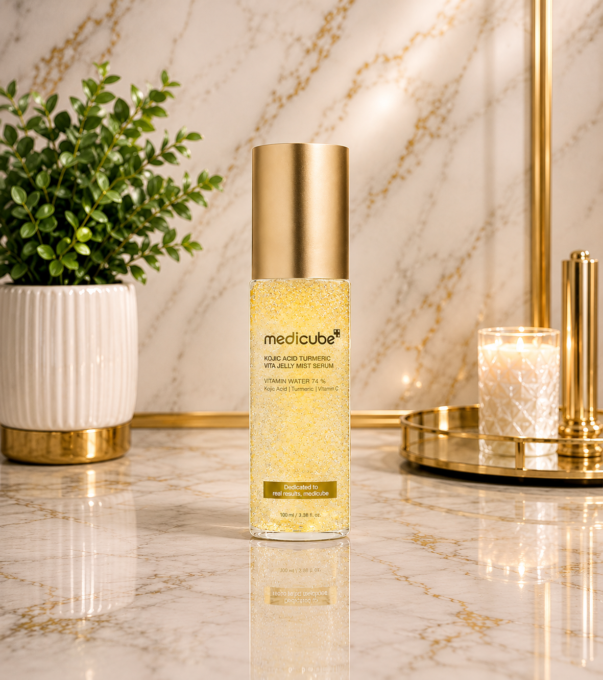Medicube Kojic Acid Turmeric Vita Jelly Mist Serum 100ml bottle on marble surface with gold accents