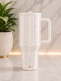 HydroJug Rose Stripe 40oz Tumbler with white handle and lid featuring pink rose stripe print on marble surface