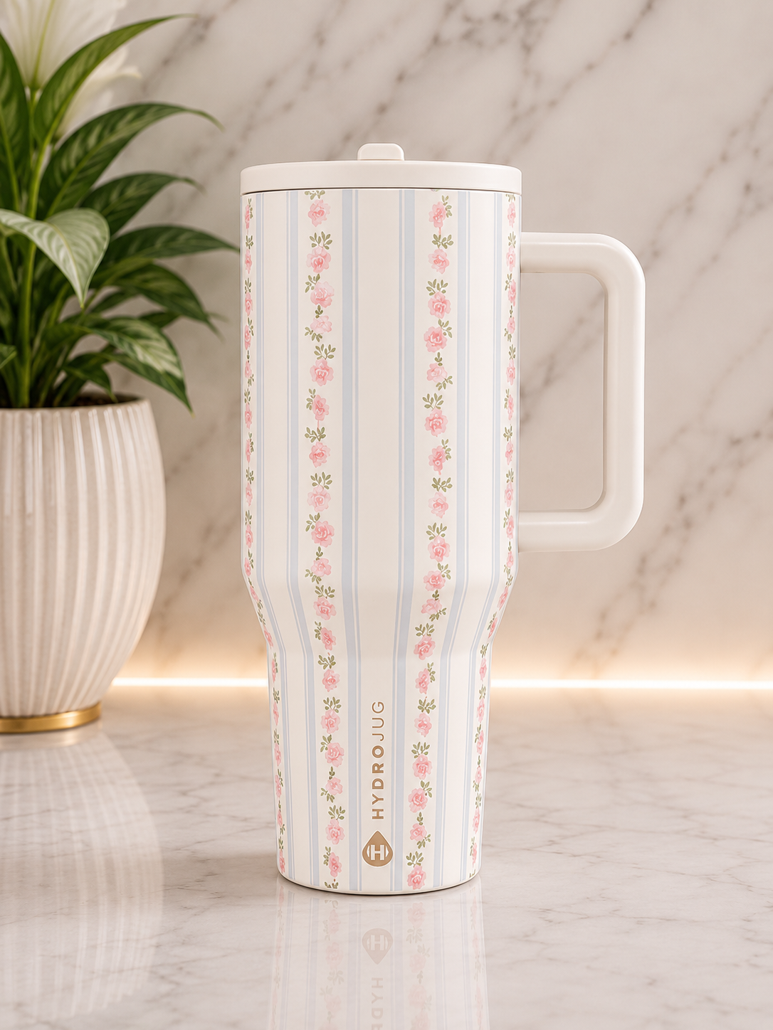 HydroJug Rose Stripe 40oz Tumbler with white handle and lid featuring pink rose stripe print on marble surface