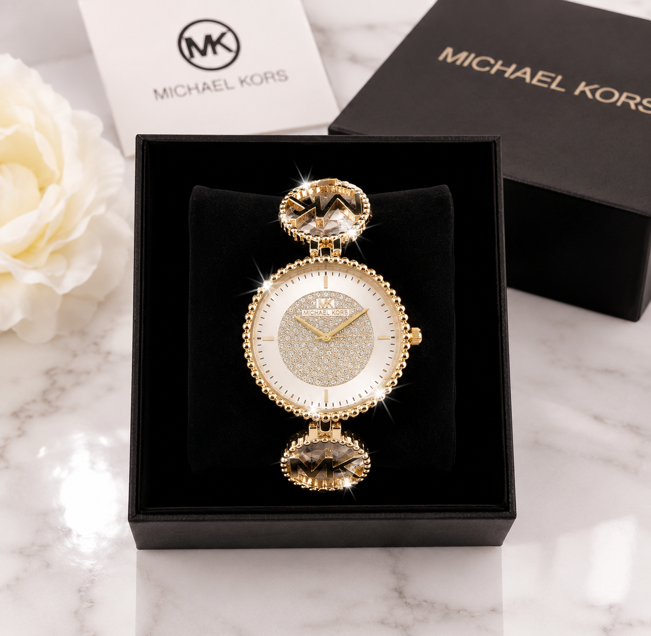 Michael Kors Ladies Fashion Quartz Watch with pave crystal dial and gold-tone MK bracelet in luxury gift box on marble surface