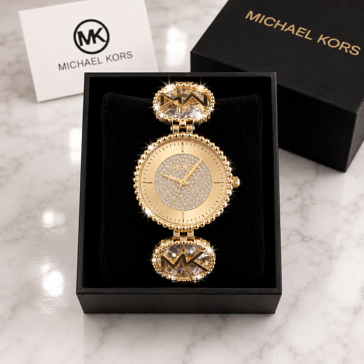 Michael Kors Ladies Quartz Watch with all-gold pave crystal dial and MK crystal oval link bracelet in luxury gift box on marble surface