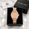 Michael Kors Ladies Quartz Watch all rose gold with pave MK logo dial and full crystal bracelet in luxury gift box on marble surface