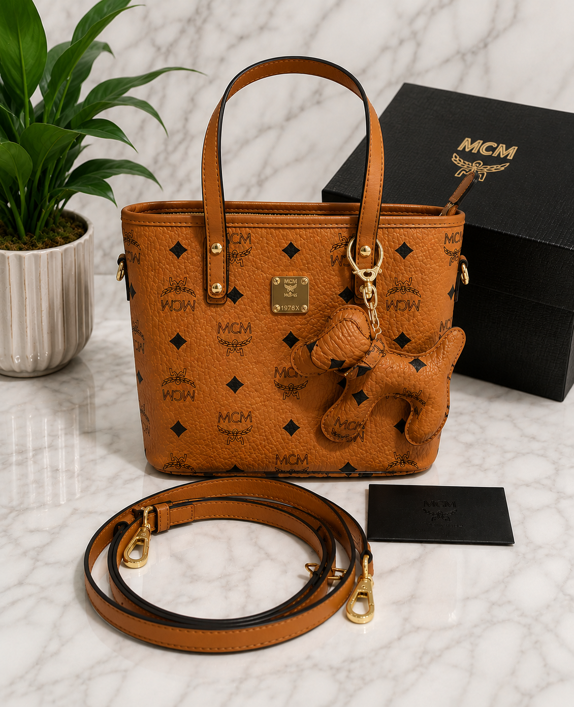 MCM Visetos Mini Tote Bag in cognac brown with bear charm and crossbody strap