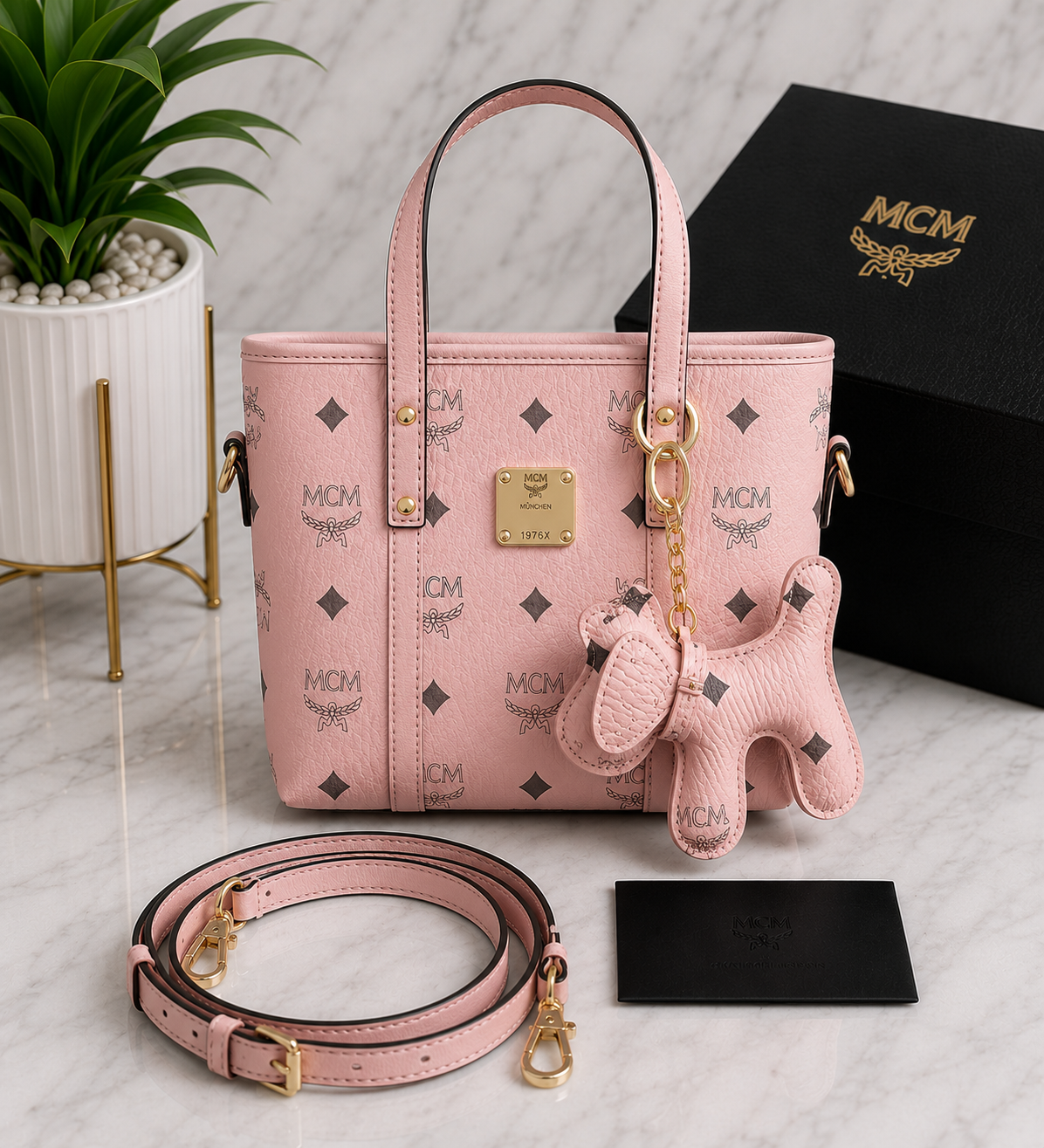 MCM Visetos Mini Tote Bag in blush pink with gold hardware, matching bear charm and crossbody strap