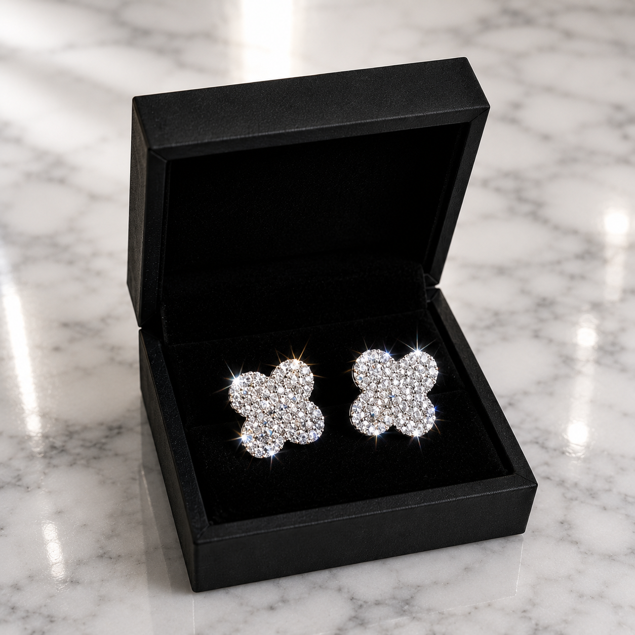 CZ Clover Pavé Stud Earrings in silver displayed in a black luxury gift box