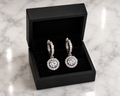 CZ Halo Drop Huggie Earrings in silver displayed in a black luxury gift box