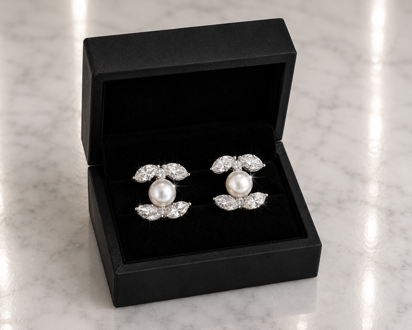 Marquise CZ and Pearl Stud Earrings in silver displayed in a black luxury gift box