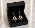 Black Onyx and CZ Diamond Huggie Drop Earrings in 18K gold tone displayed in a black luxury gift box