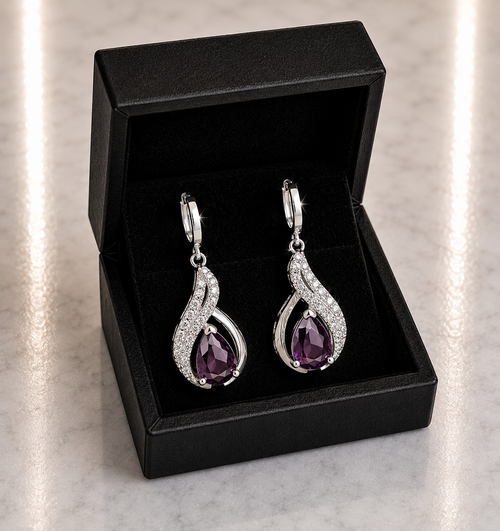 Amethyst Purple Teardrop and CZ Swirl Huggie Drop Earrings in silver displayed in a black luxury gift box
