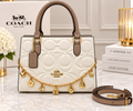 Coach white signature embossed leather tote bag with taupe leather trim, gold charm chain and detachable strap